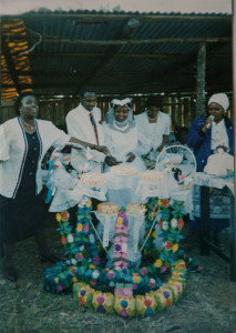 Moses Riungu and Ruth Linguli cut the cake at their wedding celebration.